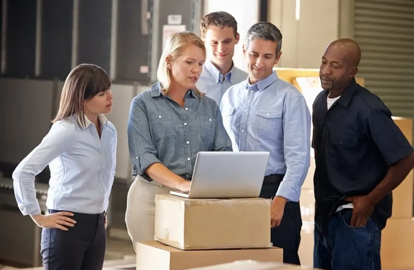 A warehouse manager with her team while optimizing their processes.