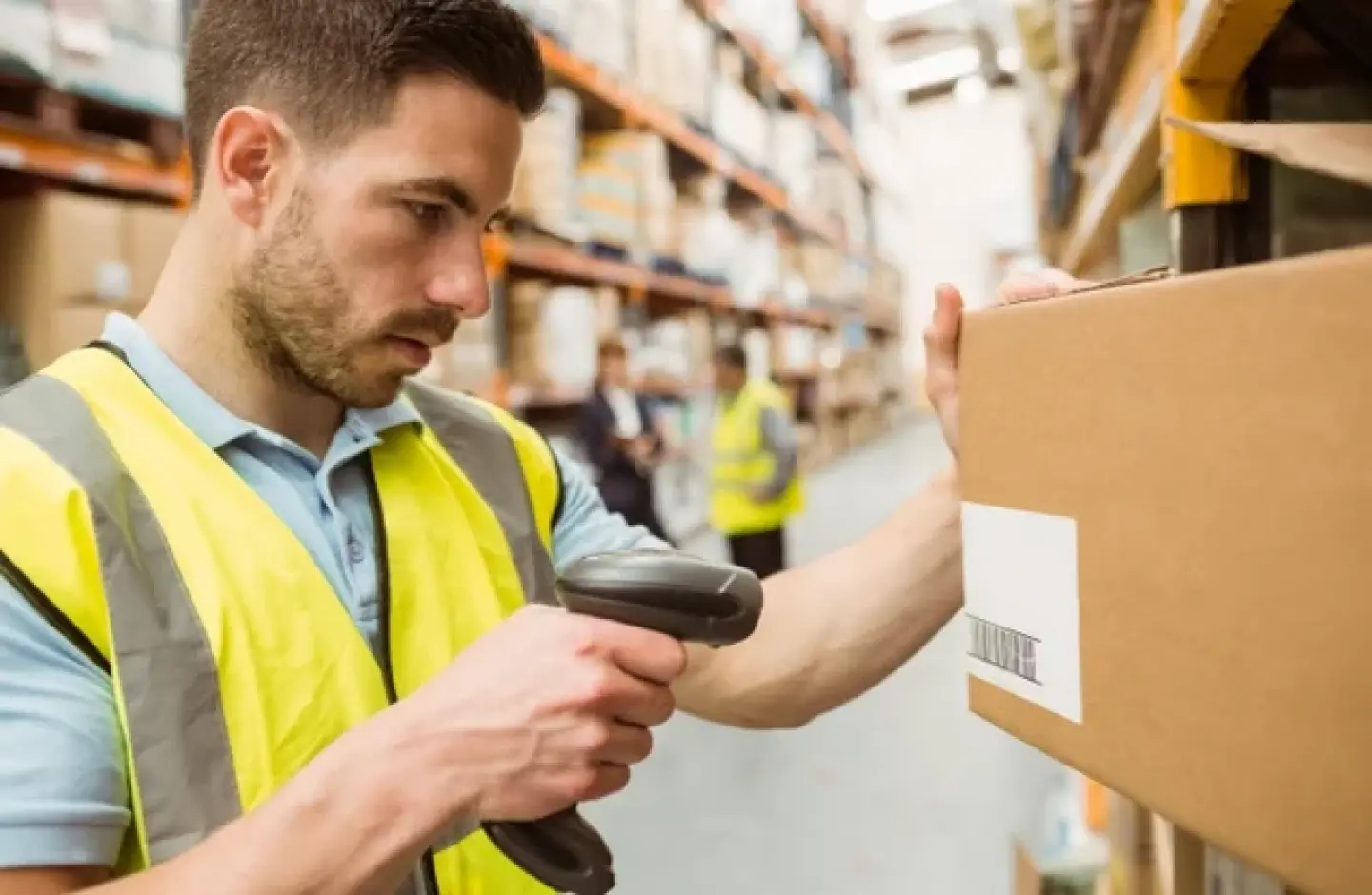 Warehouse employee using a barcode scanner.