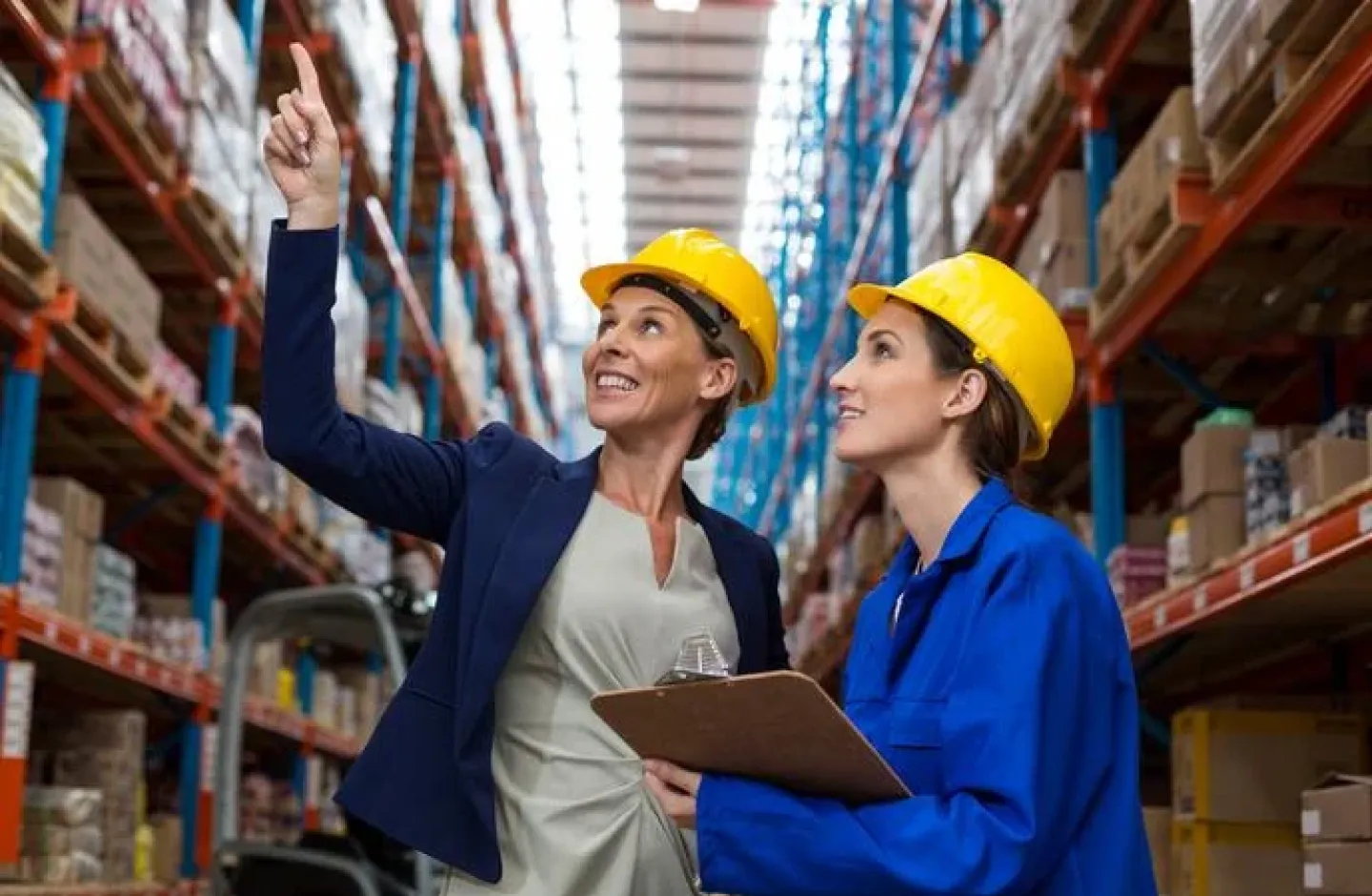 A warehouse manager being a leader to a warehouse worker.