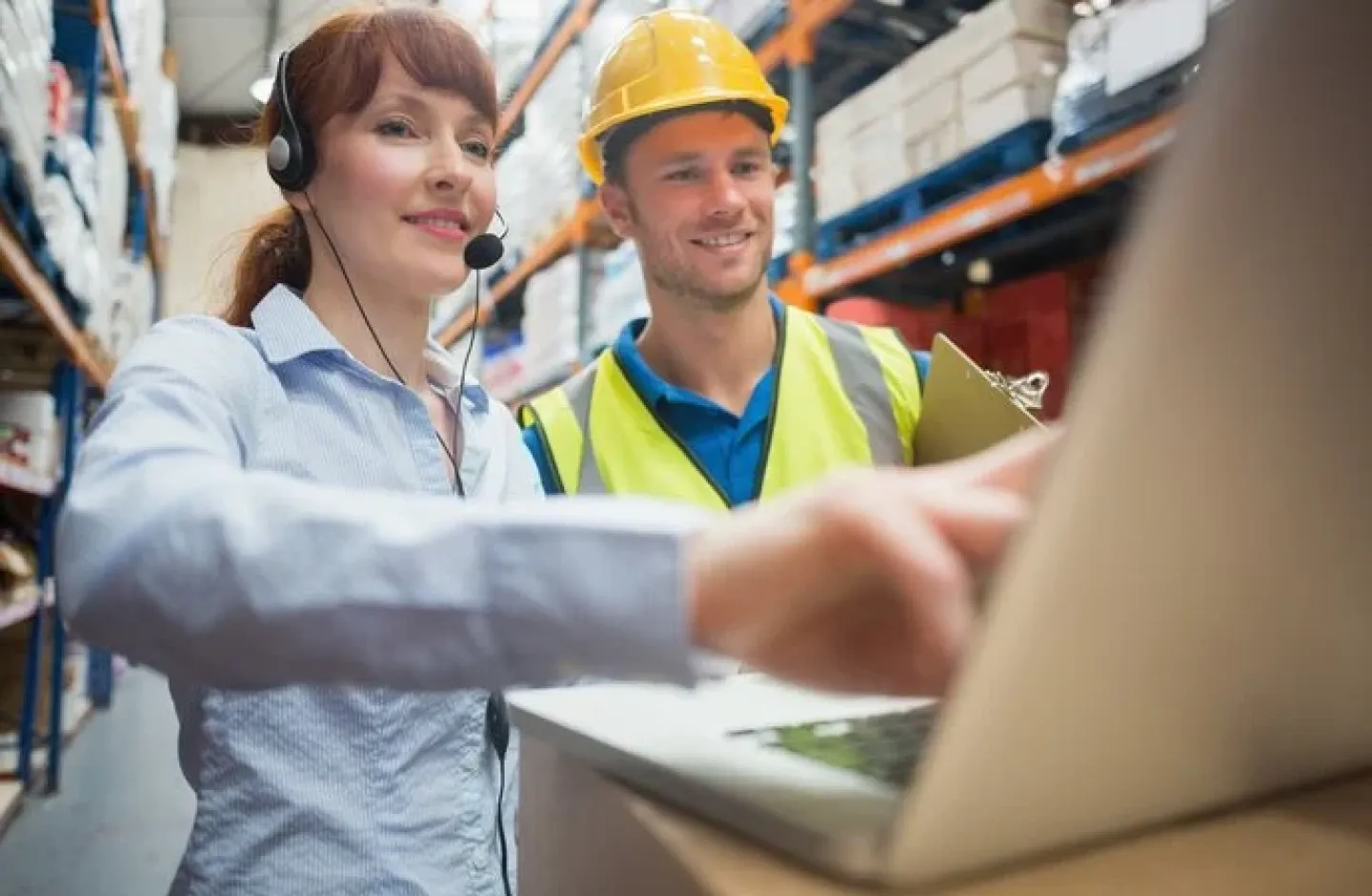 Warehouse manager training an employee