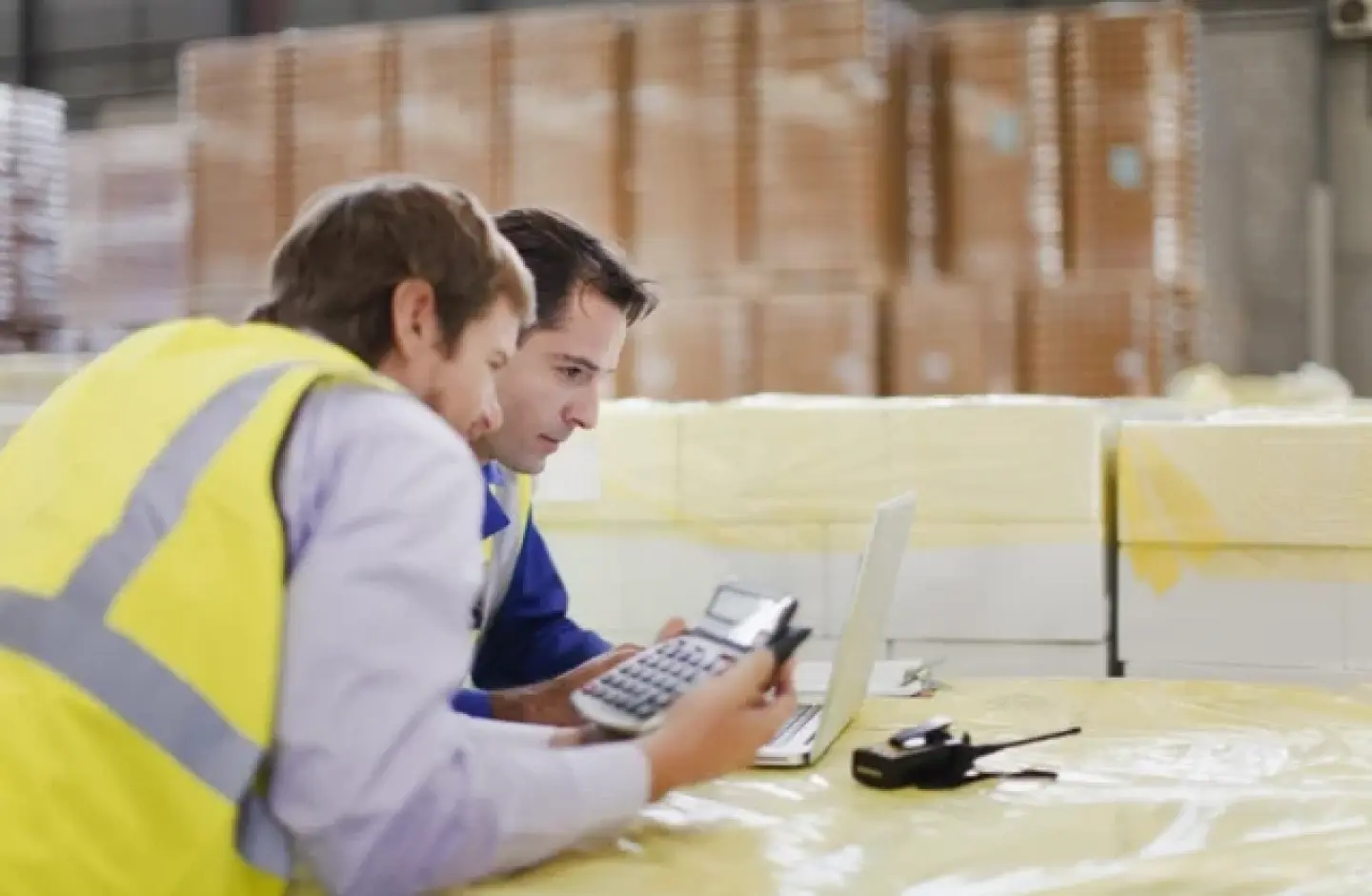 Warehouse manager calculating the cost for RFID.