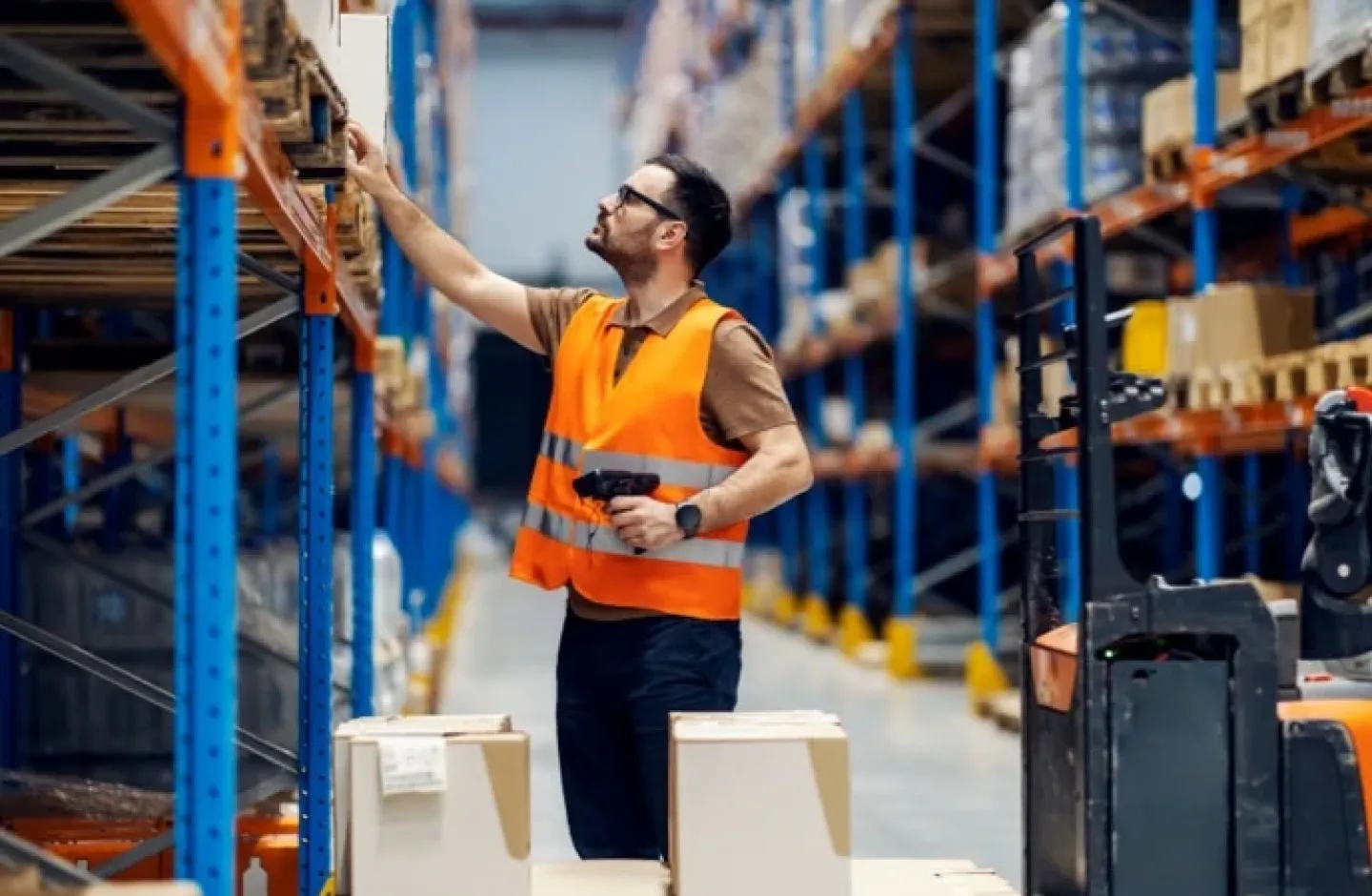 Warehouse employee with tools to ensure inventory accuracy.