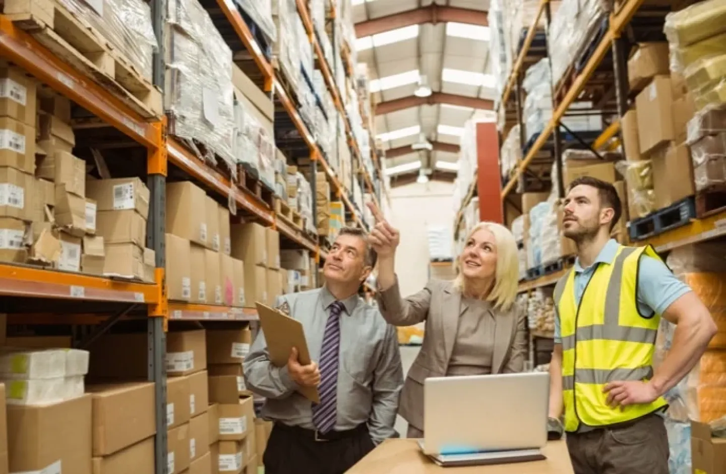 Warehouse manager and employee assessing inventory accuracy.