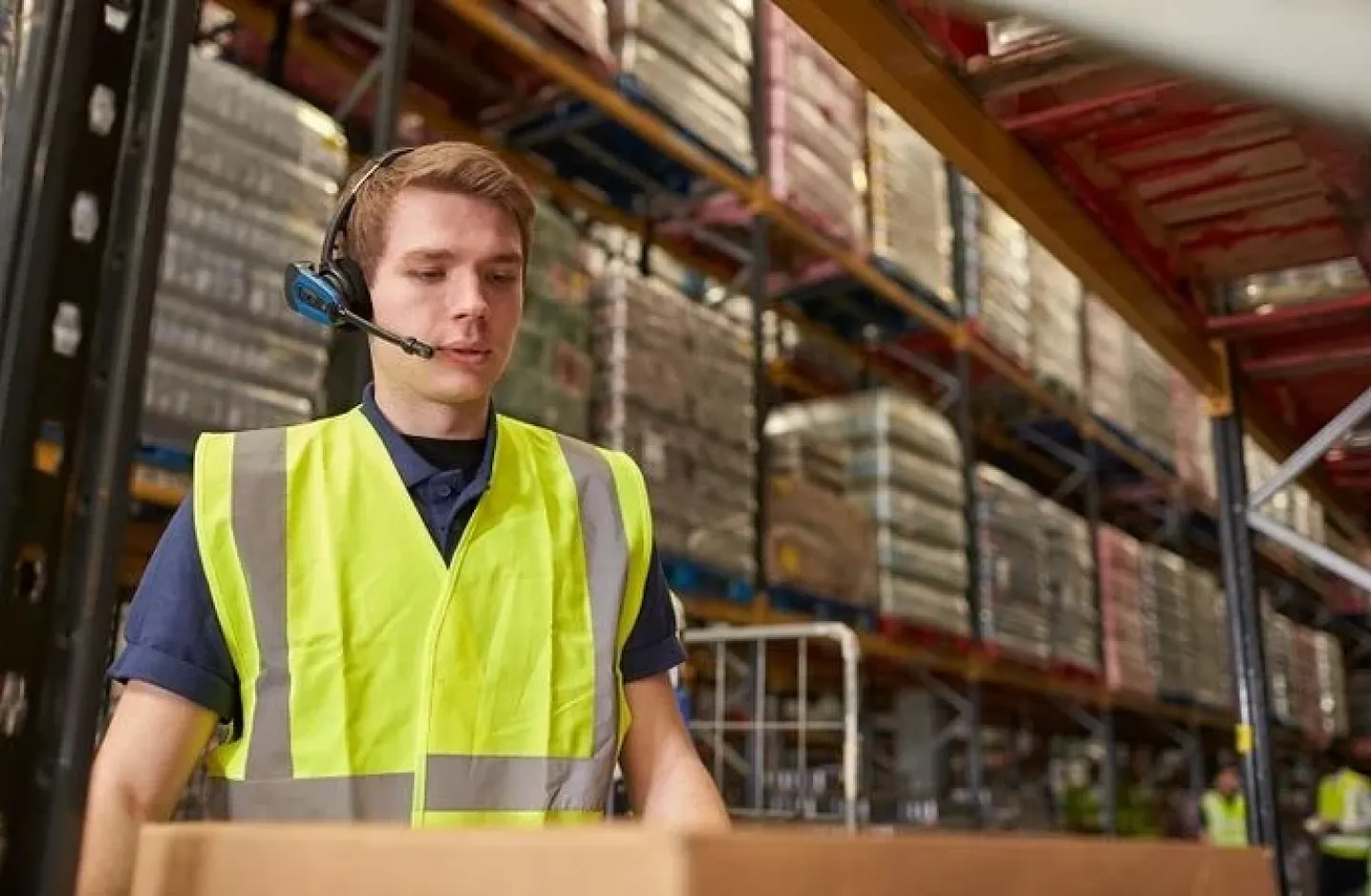 Warehouse worker wearing a voice headset.