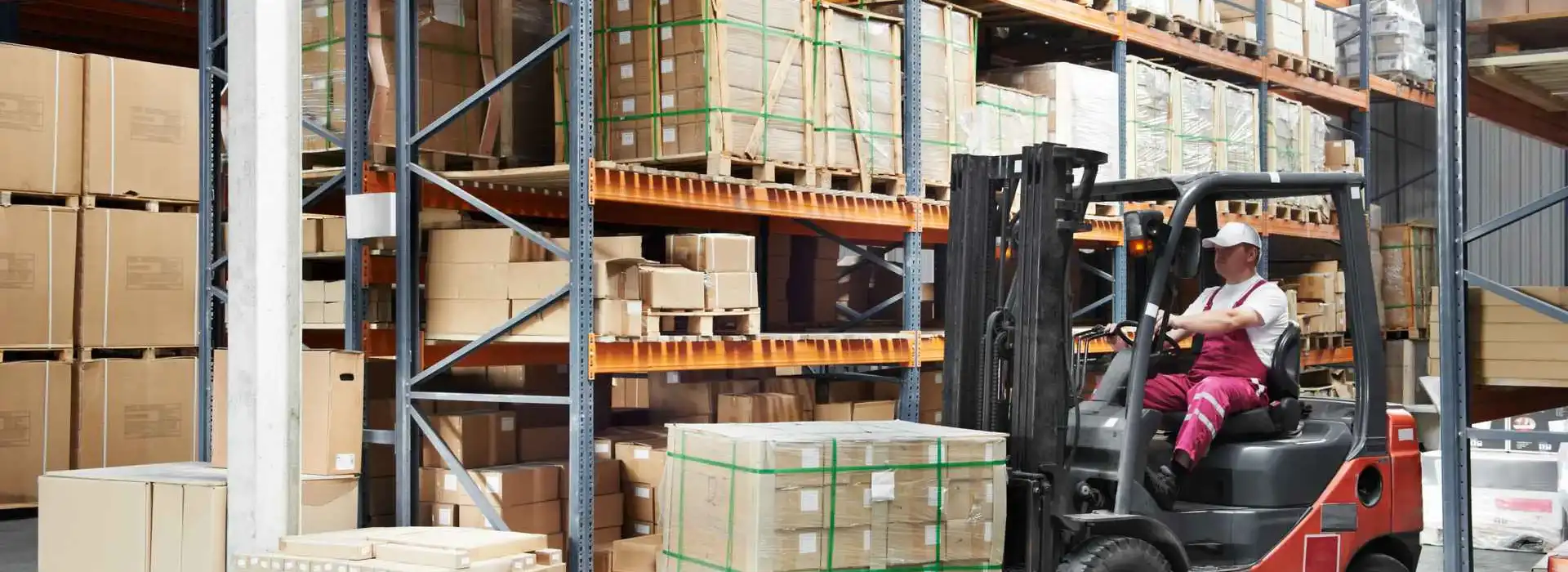 Warehouse worker on a forklift during putaway.