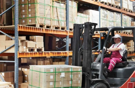 Warehouse worker on a forklift during putaway.